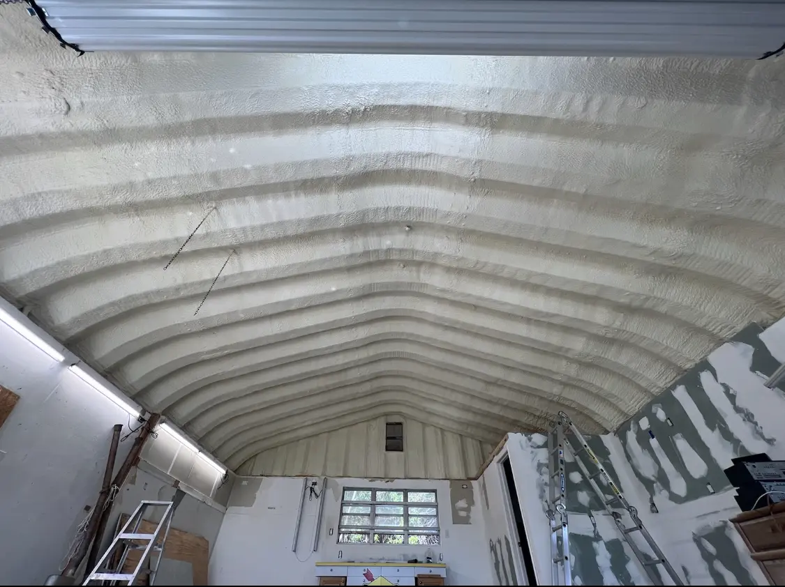 Spray polyurethane foam applied to the underside of a metal roof deck in Catskill